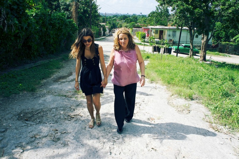 "Natalie and her mom on the street where her family lived before they fled the country." / photo by Sean Mennie